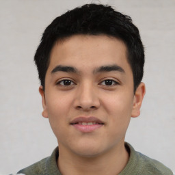 Joyful latino young-adult male with short  black hair and brown eyes