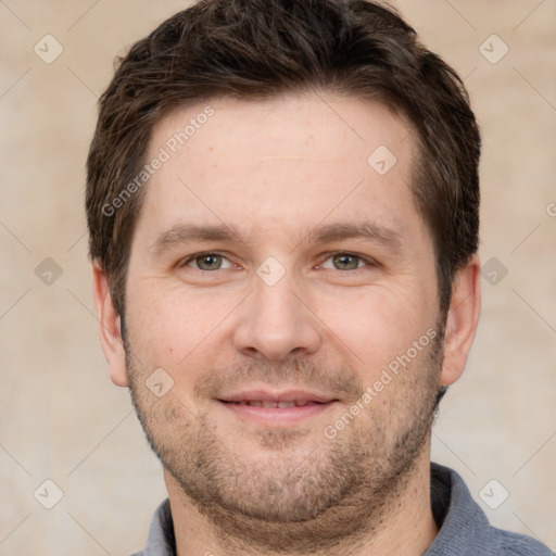 Joyful white adult male with short  brown hair and grey eyes