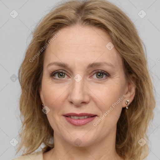 Joyful white adult female with medium  brown hair and green eyes