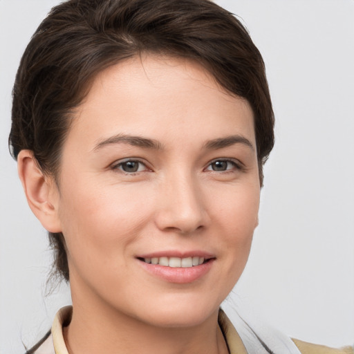 Joyful white young-adult female with short  brown hair and brown eyes