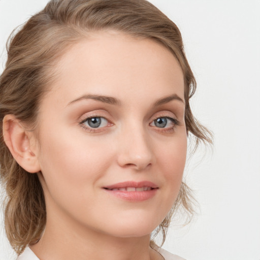 Joyful white young-adult female with medium  brown hair and blue eyes