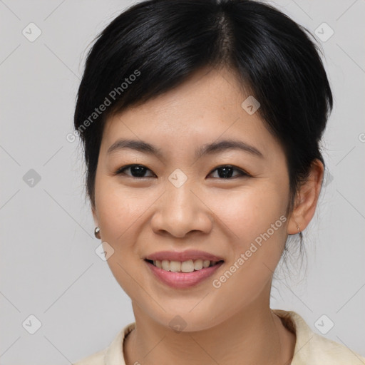 Joyful asian young-adult female with medium  black hair and brown eyes