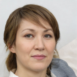 Joyful white adult female with medium  brown hair and grey eyes