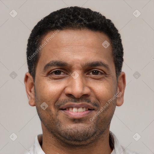 Joyful latino adult male with short  black hair and brown eyes