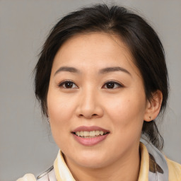 Joyful white adult female with medium  brown hair and brown eyes