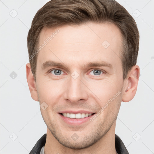 Joyful white young-adult male with short  brown hair and grey eyes