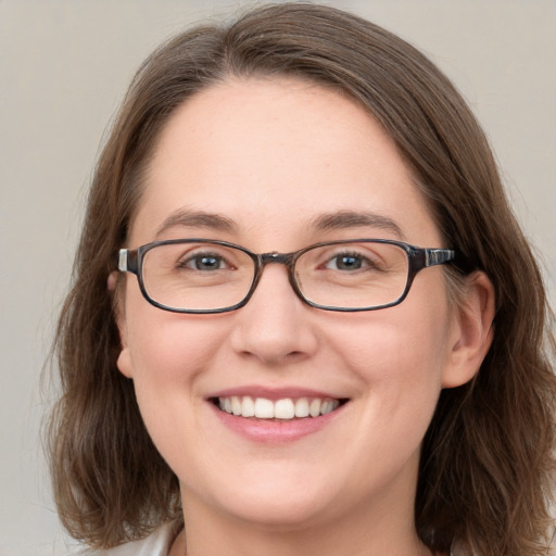 Joyful white young-adult female with medium  brown hair and blue eyes