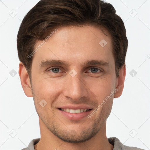 Joyful white young-adult male with short  brown hair and grey eyes