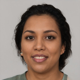 Joyful latino young-adult female with medium  brown hair and brown eyes