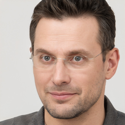 Joyful white adult male with short  brown hair and brown eyes