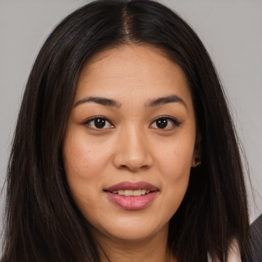 Joyful asian young-adult female with long  brown hair and brown eyes