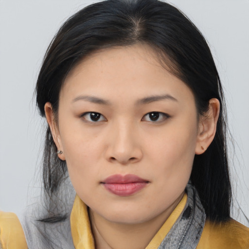 Joyful asian young-adult female with long  black hair and brown eyes