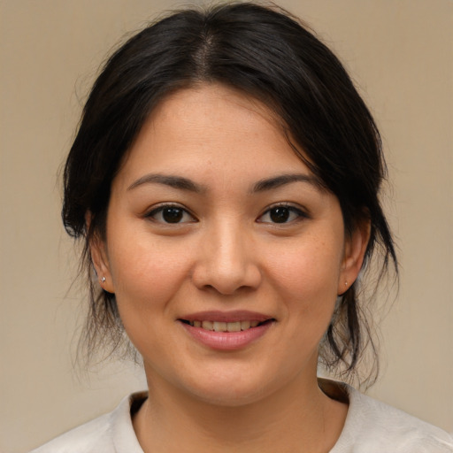 Joyful asian young-adult female with medium  brown hair and brown eyes