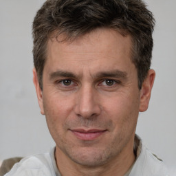 Joyful white adult male with short  brown hair and brown eyes