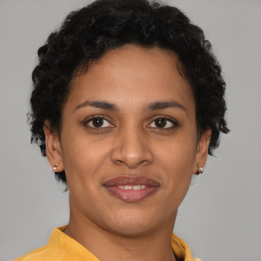 Joyful latino young-adult female with short  brown hair and brown eyes