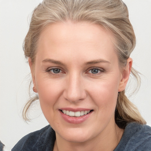 Joyful white young-adult female with medium  brown hair and blue eyes