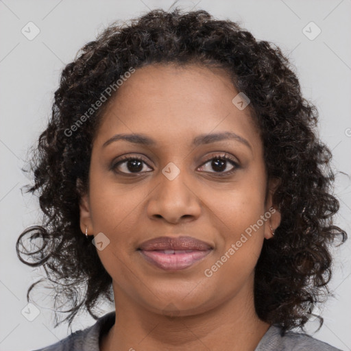 Joyful black young-adult female with medium  brown hair and brown eyes