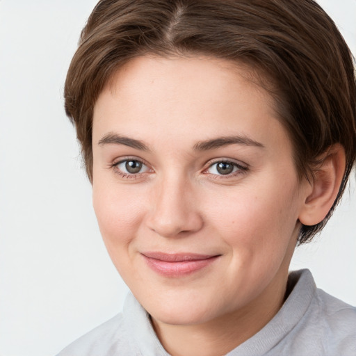 Joyful white young-adult female with medium  brown hair and grey eyes