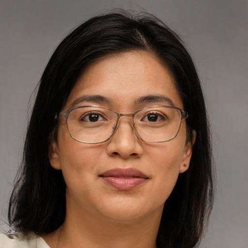 Joyful asian adult female with long  brown hair and brown eyes