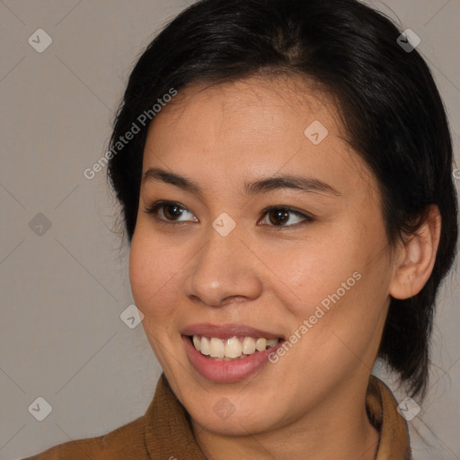 Joyful latino young-adult female with medium  brown hair and brown eyes