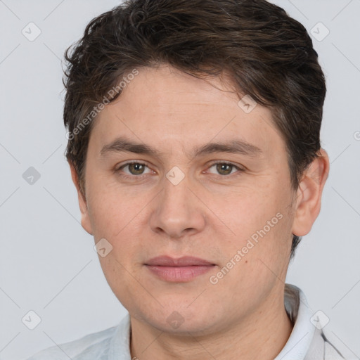 Joyful white adult male with short  brown hair and brown eyes