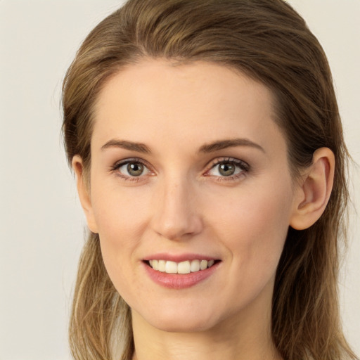 Joyful white young-adult female with long  brown hair and grey eyes