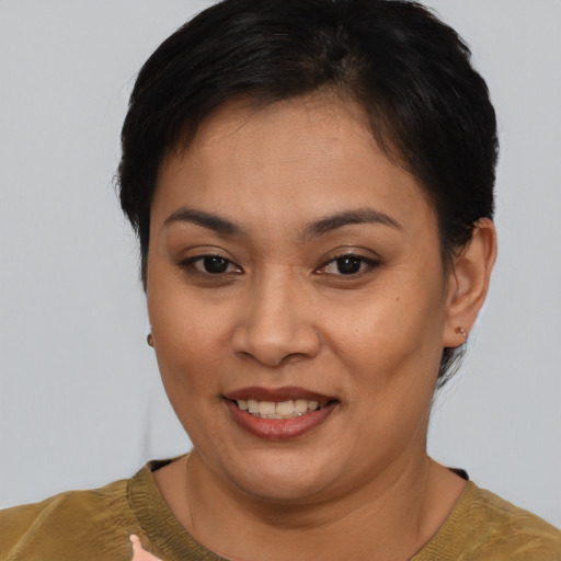 Joyful asian young-adult female with short  brown hair and brown eyes