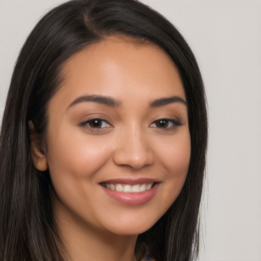 Joyful latino young-adult female with long  brown hair and brown eyes