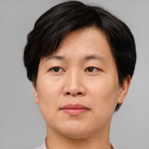 Joyful asian adult male with short  brown hair and brown eyes