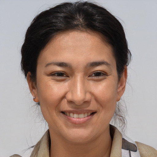 Joyful white adult female with medium  brown hair and brown eyes