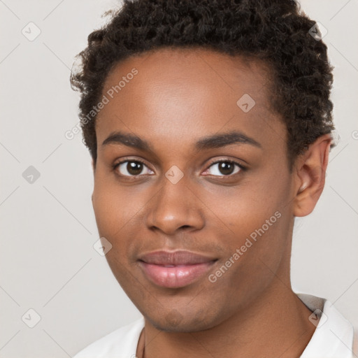 Joyful black young-adult male with short  brown hair and brown eyes