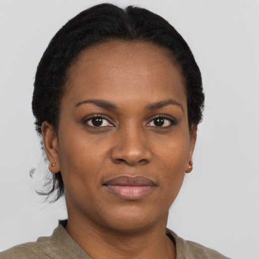 Joyful black young-adult female with short  black hair and brown eyes