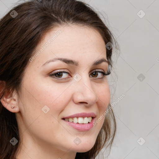 Joyful white young-adult female with long  brown hair and brown eyes