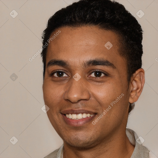 Joyful black young-adult male with short  brown hair and brown eyes