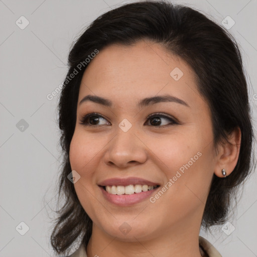 Joyful latino young-adult female with long  brown hair and brown eyes