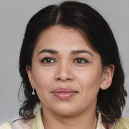 Joyful latino young-adult female with medium  brown hair and brown eyes