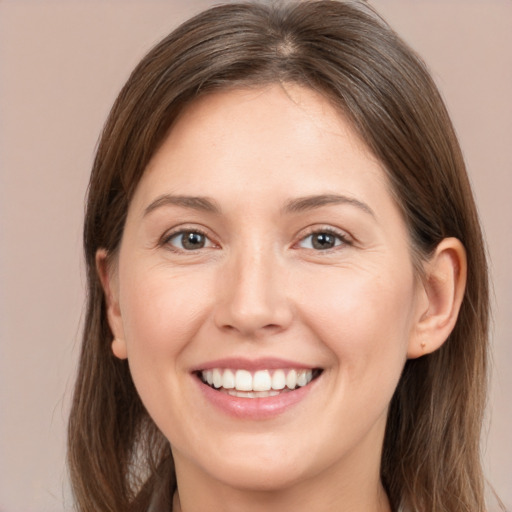 Joyful white young-adult female with long  brown hair and brown eyes