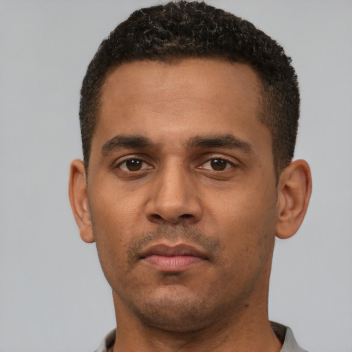 Neutral latino young-adult male with short  brown hair and brown eyes