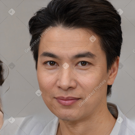 Joyful white adult male with medium  brown hair and brown eyes