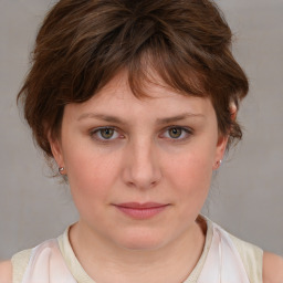 Joyful white young-adult female with medium  brown hair and blue eyes