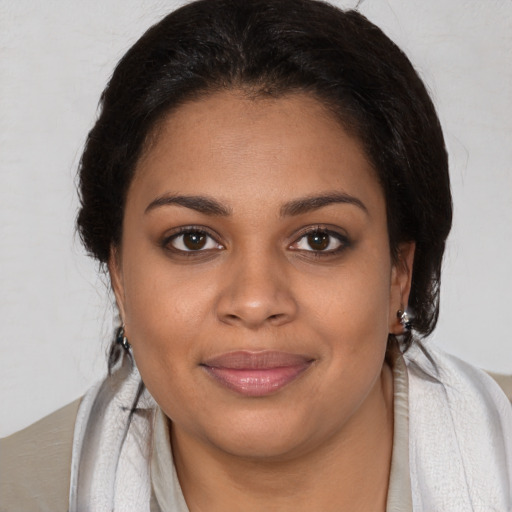 Joyful black young-adult female with medium  brown hair and brown eyes