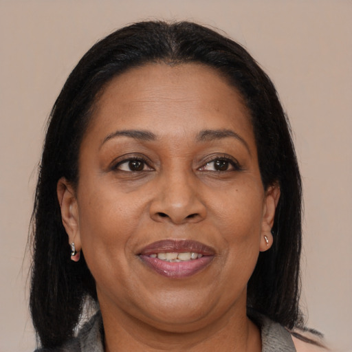 Joyful black adult female with medium  brown hair and brown eyes