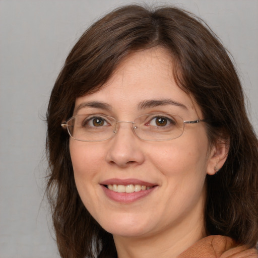 Joyful white adult female with medium  brown hair and brown eyes