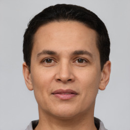 Joyful white adult male with short  brown hair and brown eyes