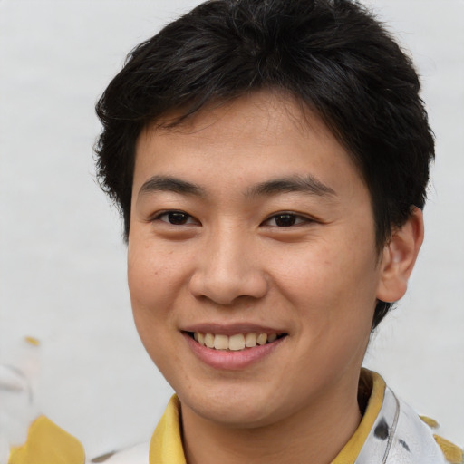 Joyful asian young-adult male with short  brown hair and brown eyes