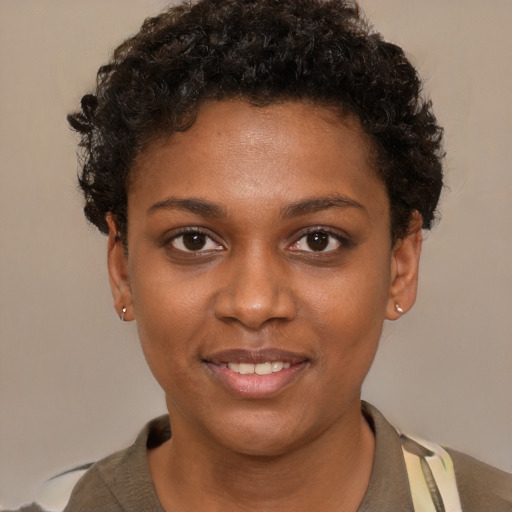Joyful black young-adult female with short  brown hair and brown eyes