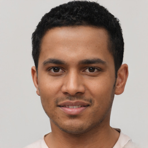 Joyful latino young-adult male with short  black hair and brown eyes