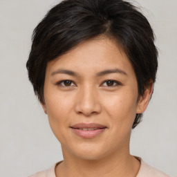 Joyful asian young-adult female with short  brown hair and brown eyes