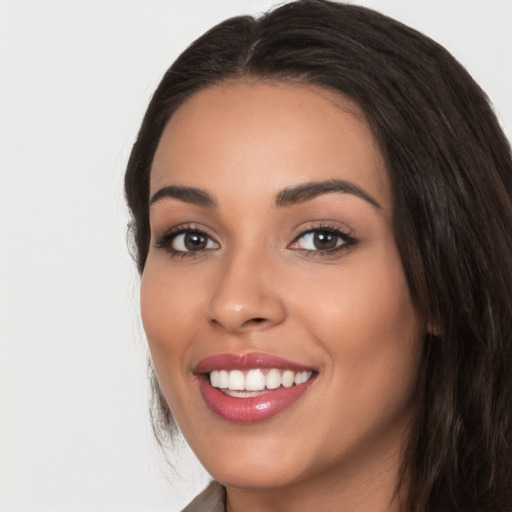 Joyful white young-adult female with long  black hair and brown eyes