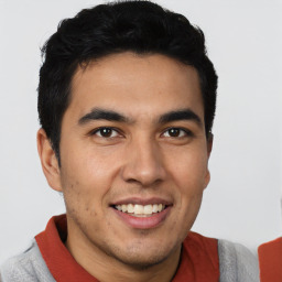 Joyful latino young-adult male with short  brown hair and brown eyes